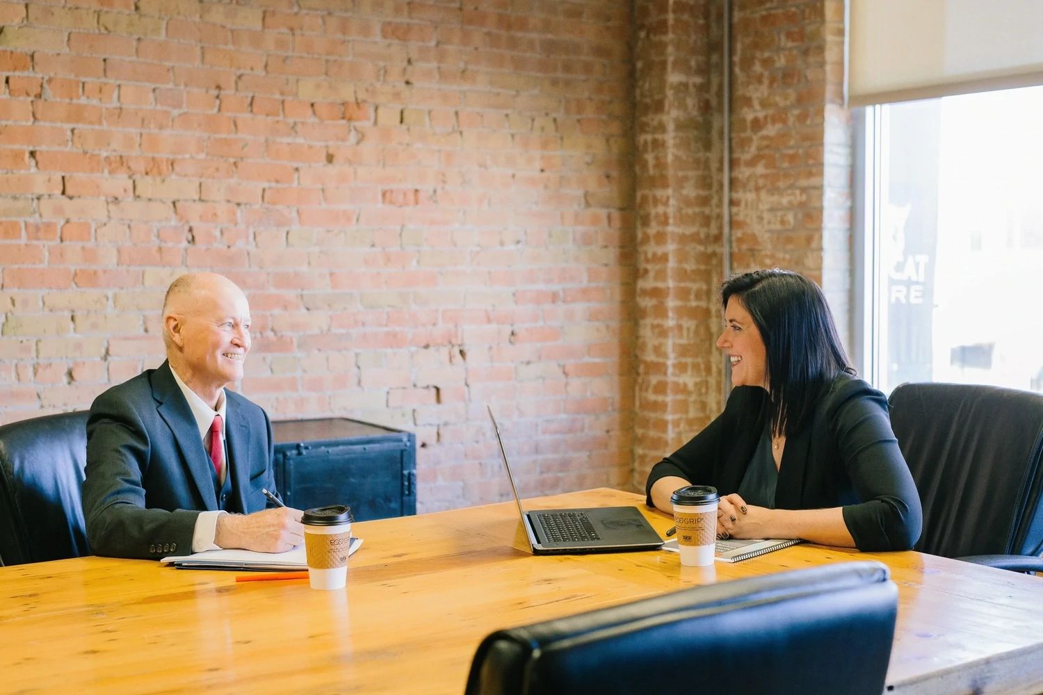 Company director at a desk discussing the home address search service 