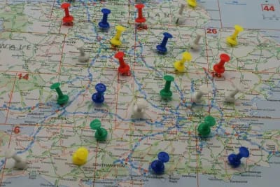 Map with pins in it to show a people tracing service working
