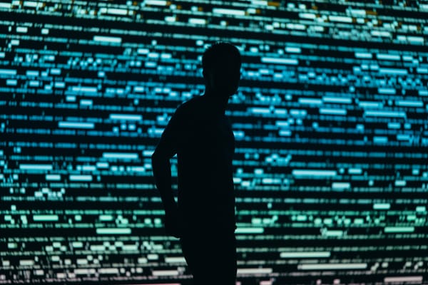 Person in front of a people tracing display of data