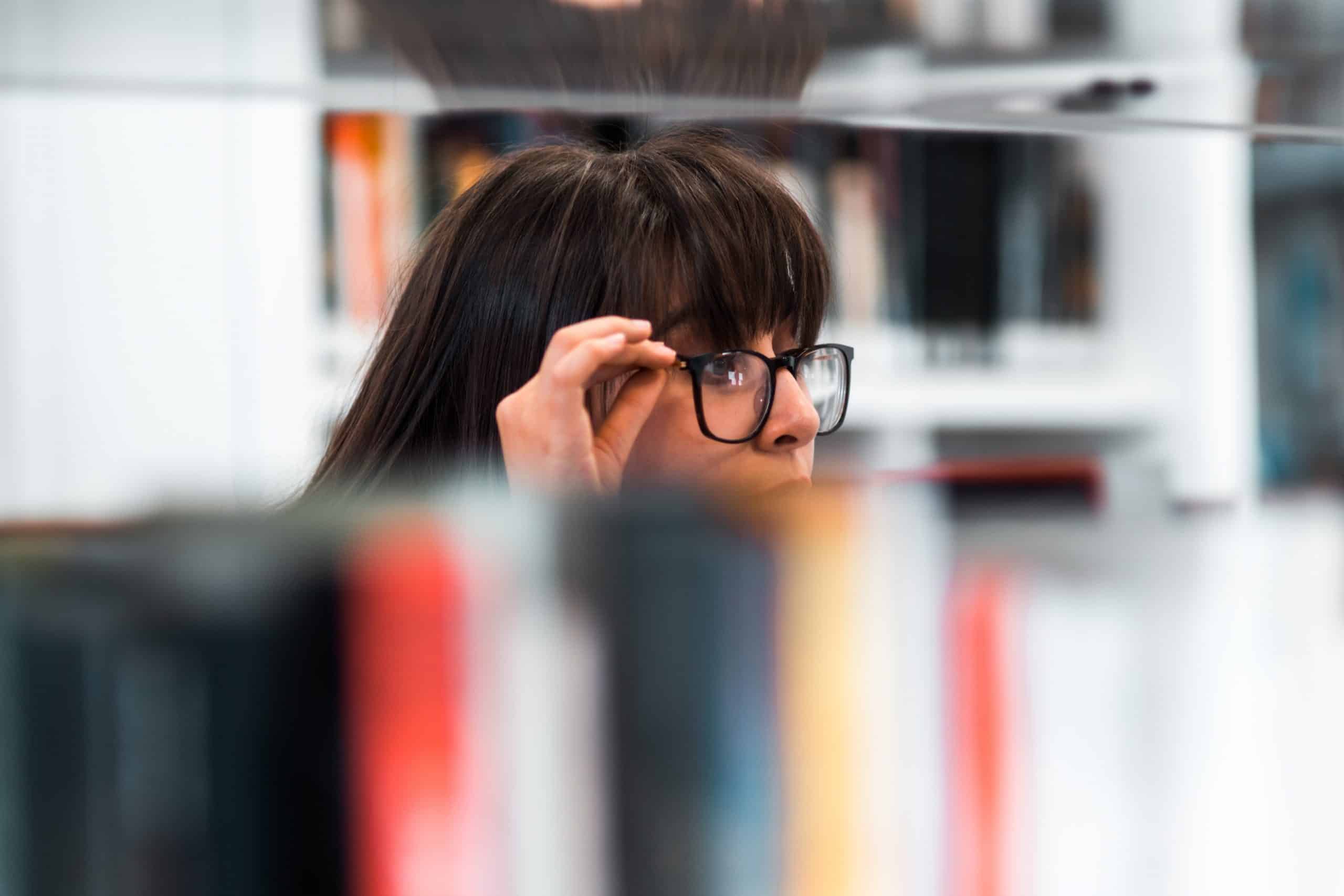 A female people finder from the Find UK People offices sitting at their desk researching a people location case