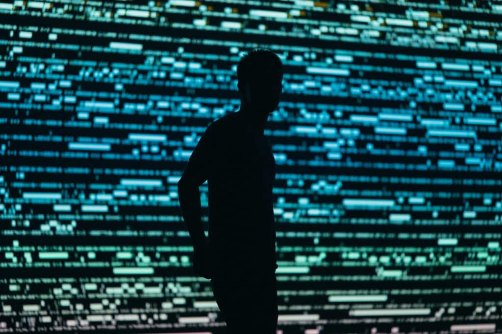 Person in front of a people tracing display of data
